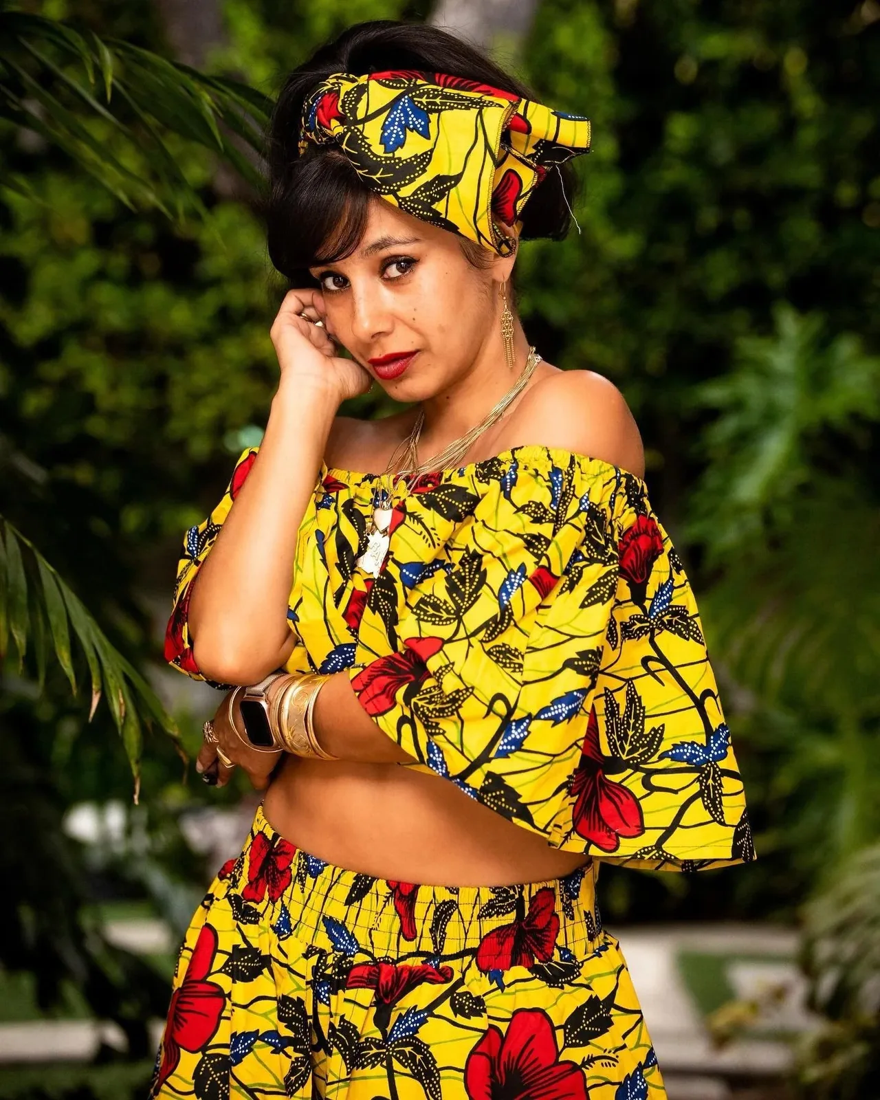 Ranagade in a yellow print outfit in a garden