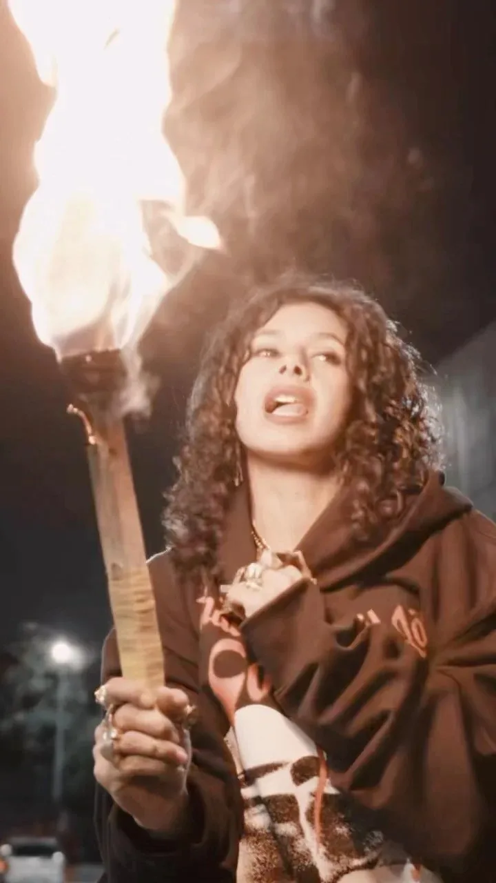 Ranagade holding a lit torch at night